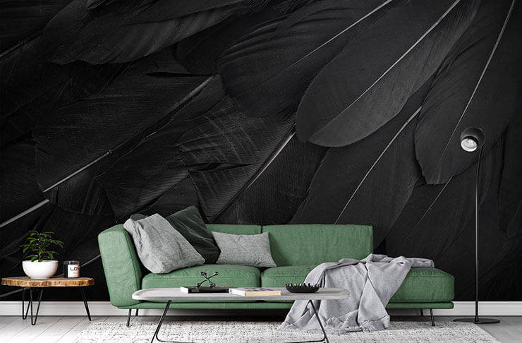 enlarged black raven feather wallpaper in lounge with green couch and black accessories