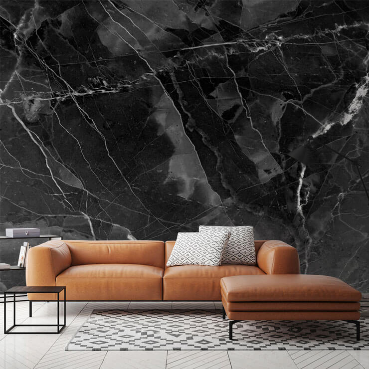 black marble with white flecks wallpaper in lounge with brown tan leather sofa