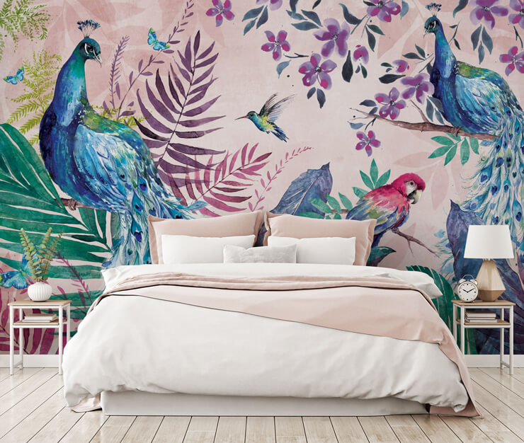 pink wallpaper set in jungle with peacocks, a parrot, a hummingbird and flowers wallpaper in master bedroom with white and pink bed