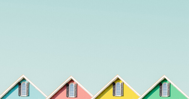 pink, blue, green and yellow house roof tops