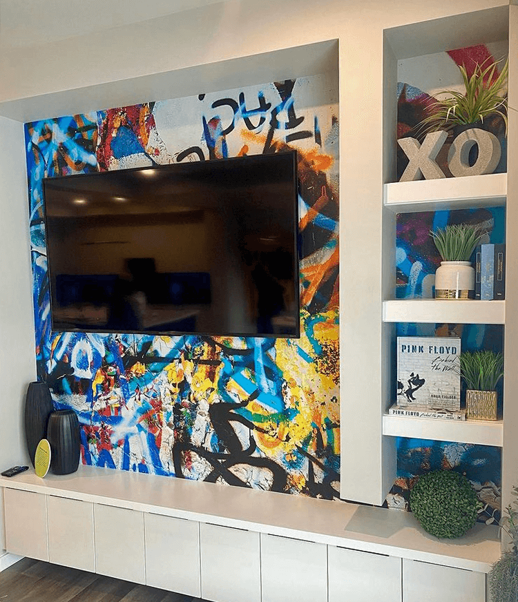 mounted large tv screen on graffiti wall mural