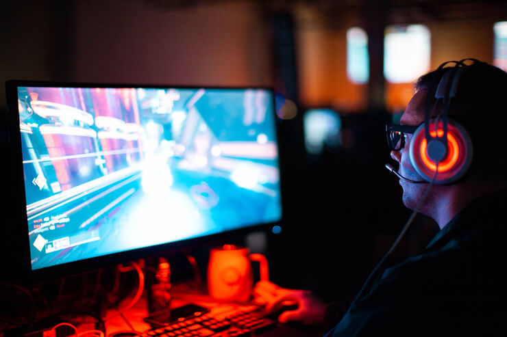 Gamer in gamer room with LED headset