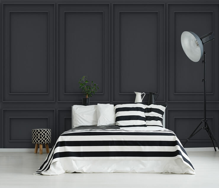 black panel effect wallpaper in bedroom with black and white striped bedding