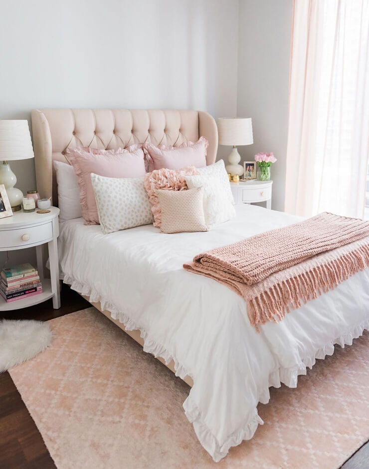 white and pink double bed with ruffled bedding