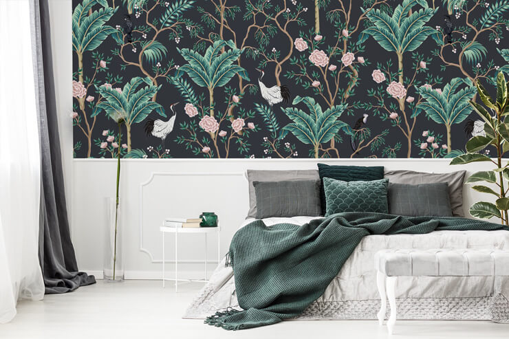 dark wallpaper with palm tree, pink flower and bird pattern in bedroom with green and white bed