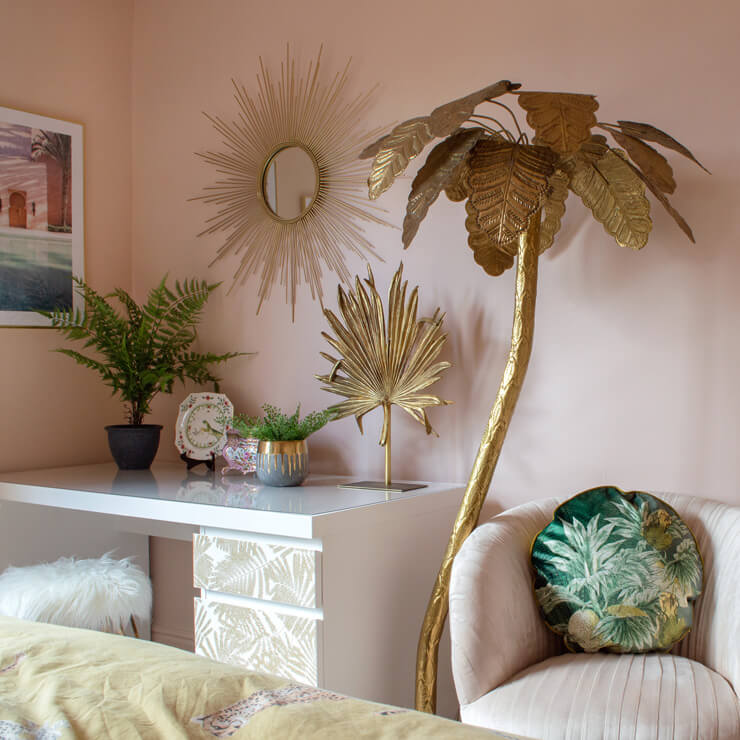 tall golden palm tree sculpture, golden sunburst mirror in pink bedroom