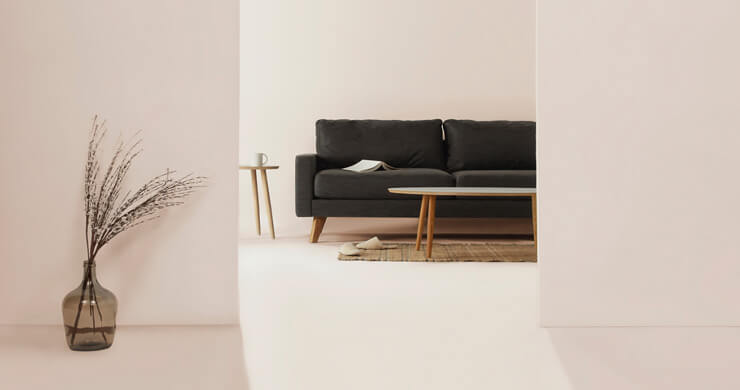 white, minimalist living room in rented property with black sofa 