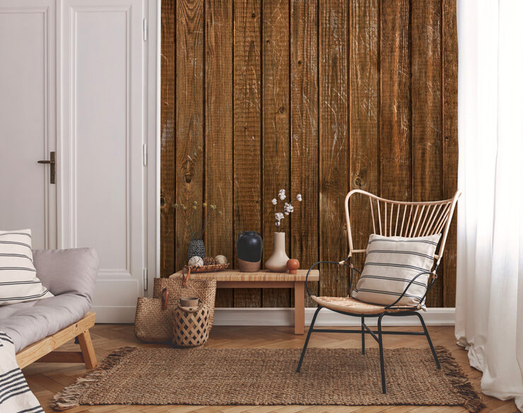 rustic wood panel wallpaper in lounge with natural wicker chair, lamp and rattan rug