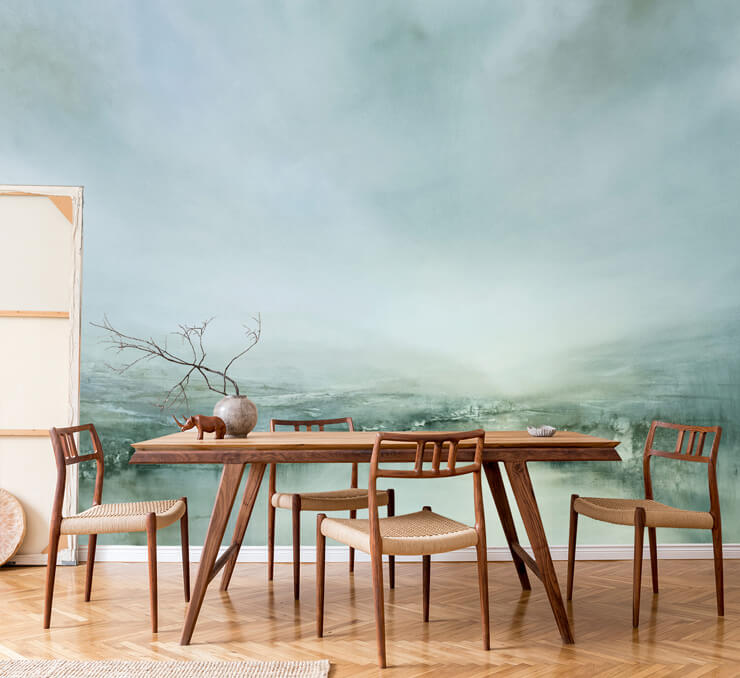 very pale green abstract landscape painting wallpaper in dining room with sleek wooden table and chairs