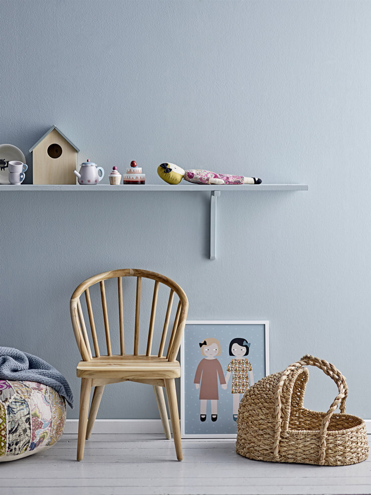 gray painted nursery with shelf and wicker moses basket