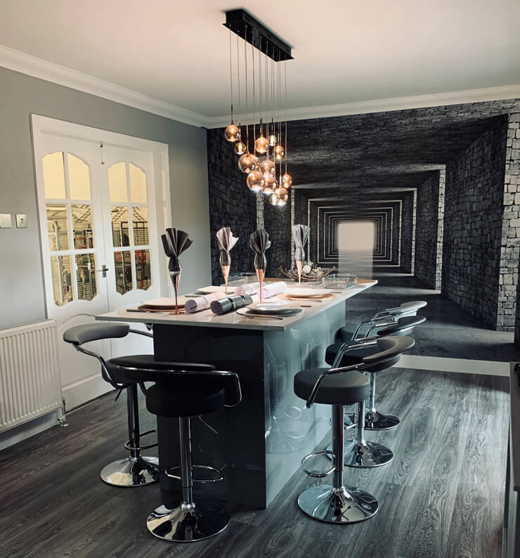 white, gray and rose-gold kitchen with breakfast bar island and 3D gray tunnel feature wall