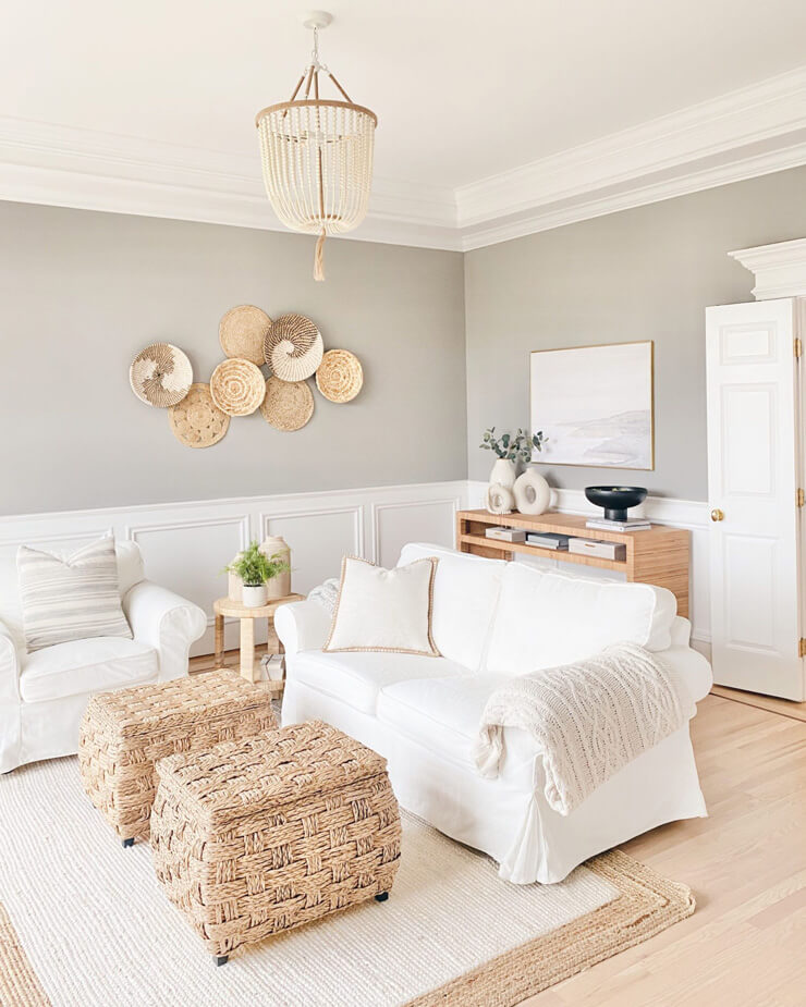 greige painted walls in living room with white panelling and white couch