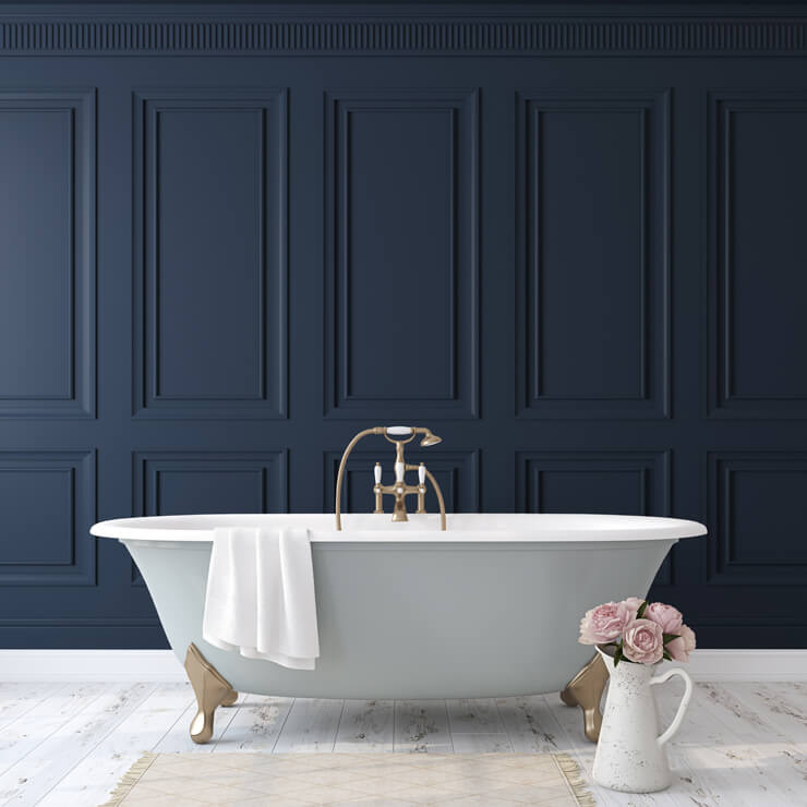 navy-blue wood panel wallpaper in bathroom with free standing grey and white bath