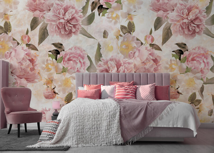 off-white, pastel pink, yellow and green floral wallpaper in pretty bedroom with pink accessories and pink chair
