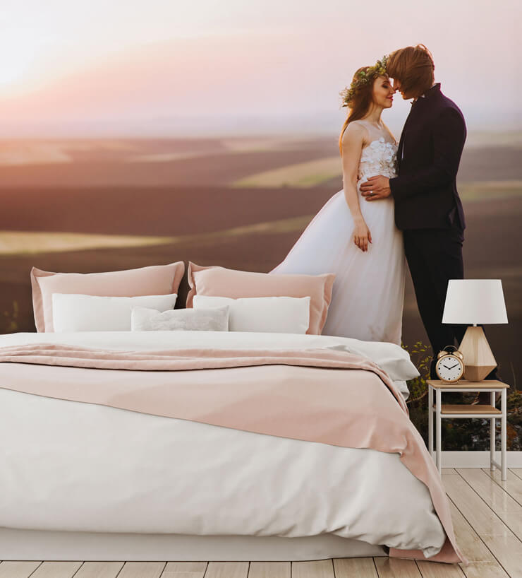 photo of married couple statement wallpaper in bedroom with pink and white bed