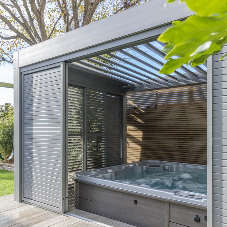 luxurious grey summer house with large hot tub inside