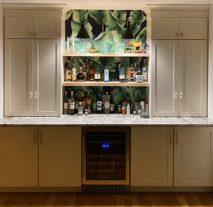 dark background with green large leaf wallpaper in kitchen opening shelving