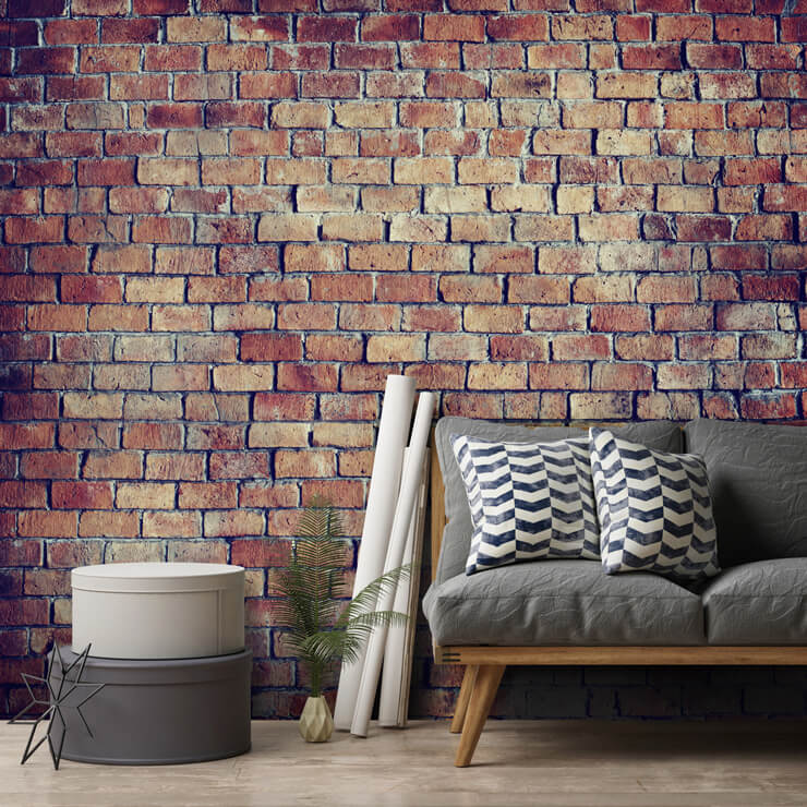 red brick effect wallpaper in lounge with grey couch