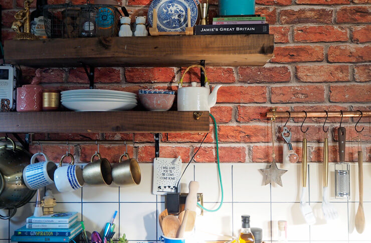 red brick effect wallpaper in funky customer kitchen