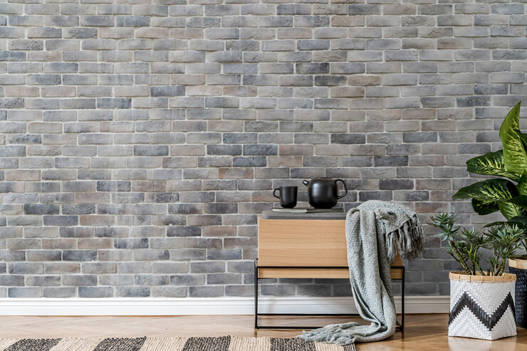 light grey brick industrial wallpaper with wooden storage and black teapot