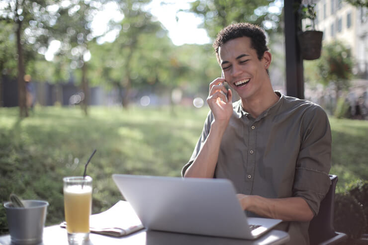 young man in outdoor office talking on phone