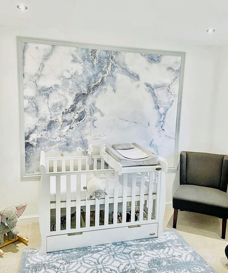 blue and white marble effect framed wallpaper in baby's nursery