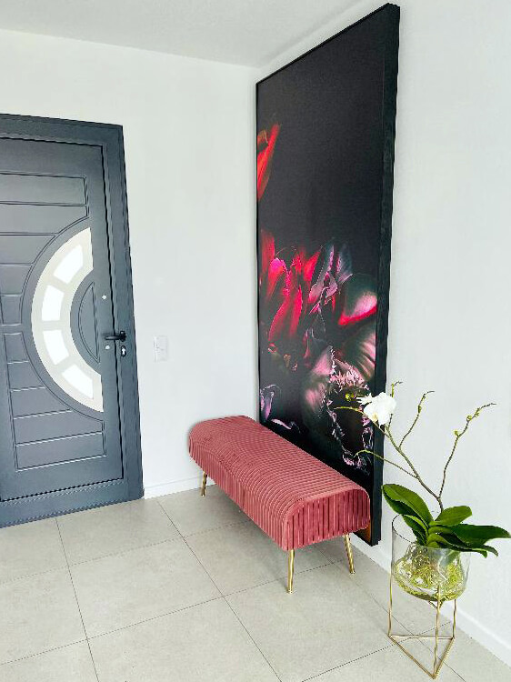 black and pink dark floral wallpaper framed in hallway