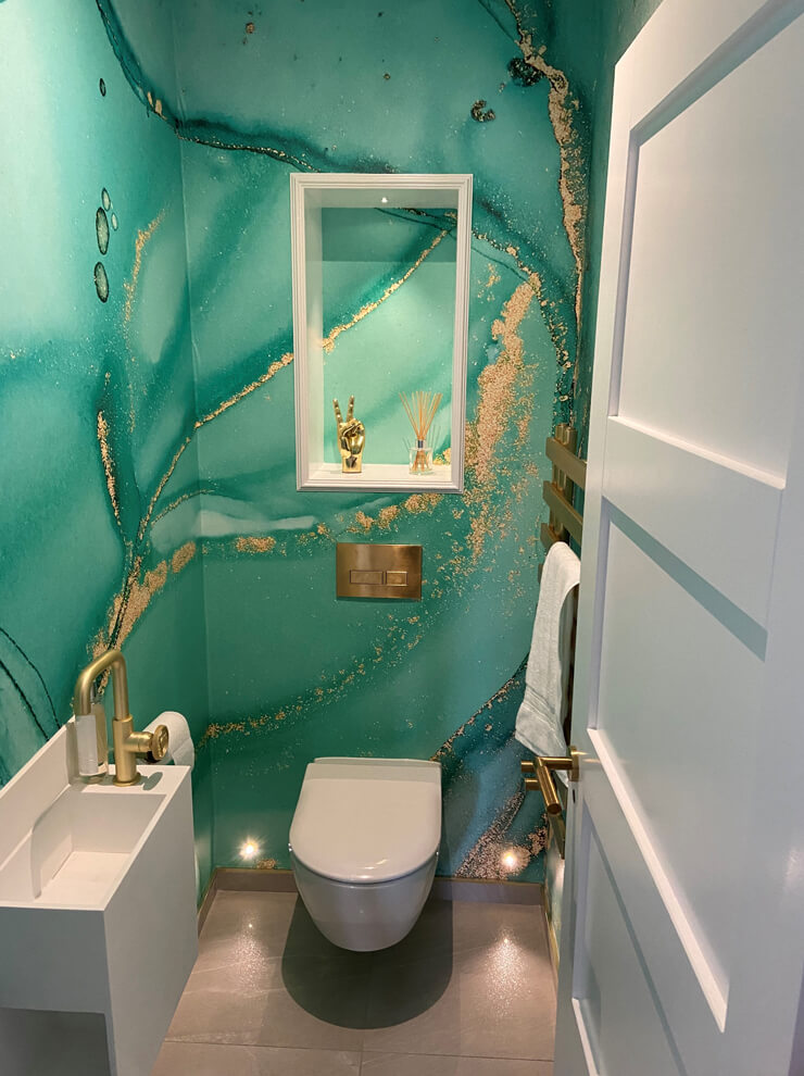 turquoise green and gold watercolour wallpaper in toilet room