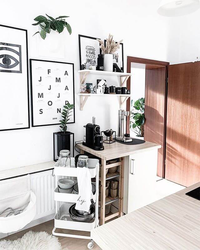 white coffee station with black and white art on walls