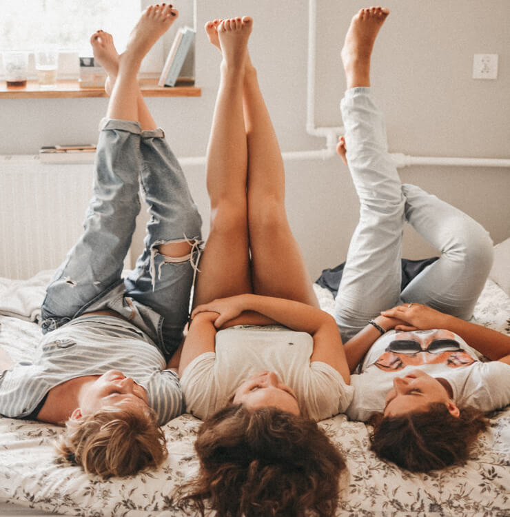 girl roommates lying on bed