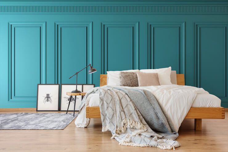 green panel effect wallpaper in cosy bedroom following bedroom trends for 2022