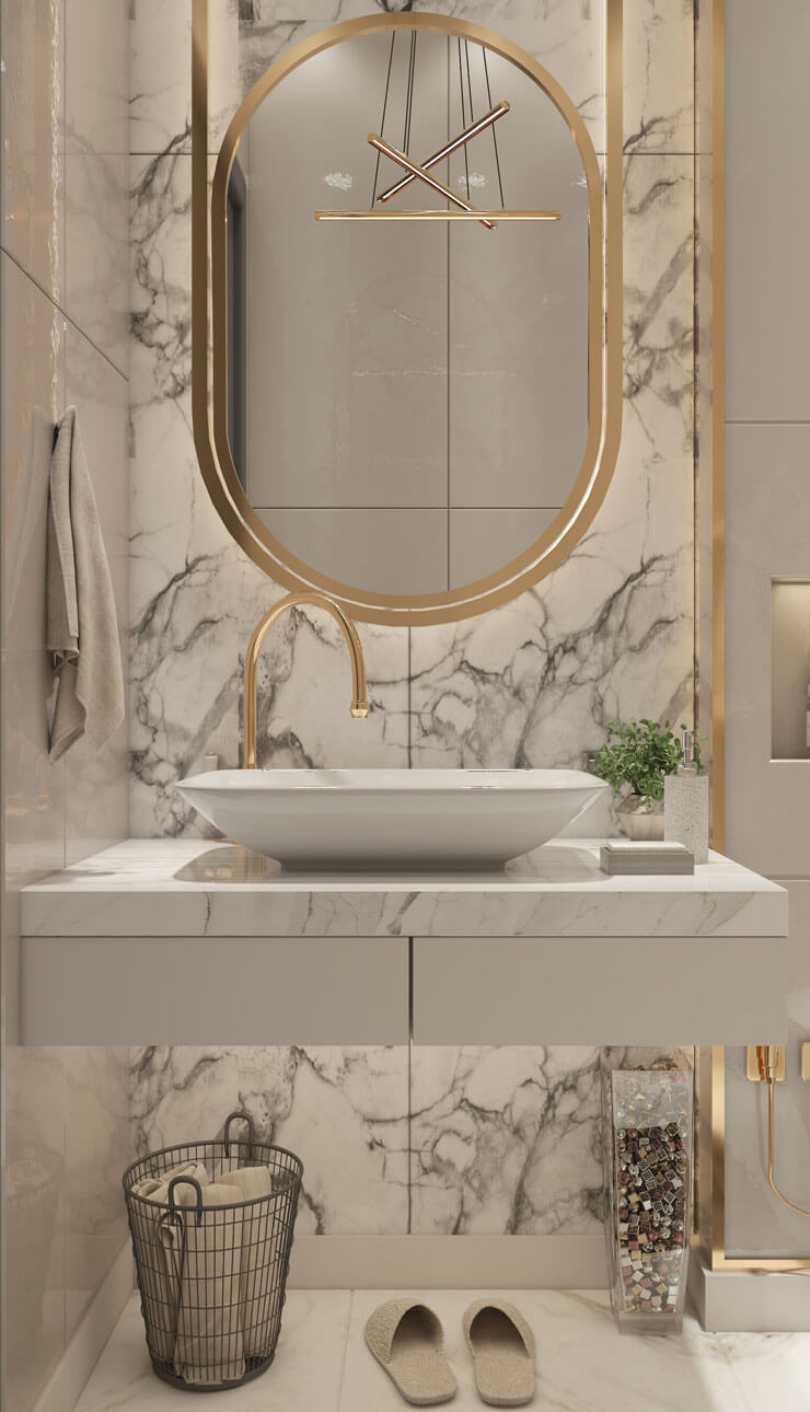 marble tiles, white sink and gold mirror