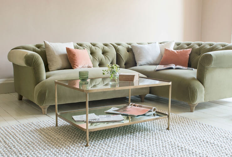 light green and pink couch with glass coffee table