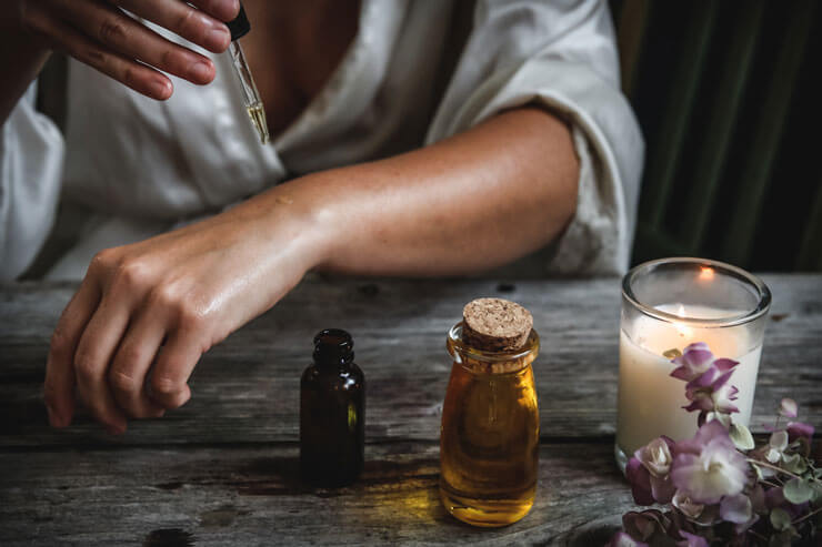 woman trying on aromatherapy oils