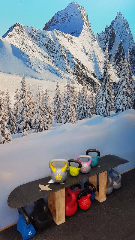 Ski inspired home gym ideas with snowy wallpaper
