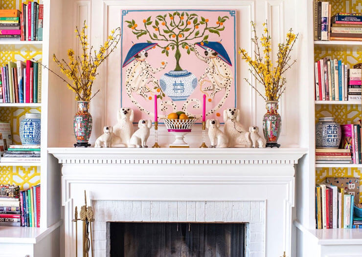 vintage mantelpiece decorated with antiques and colourful candles and vases