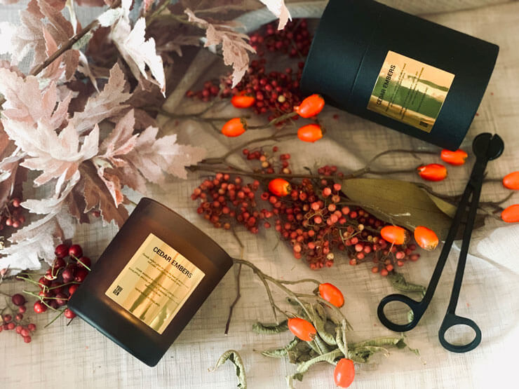 luxurious christmas gift ideas 2021 candles on table laid with autumnal berries