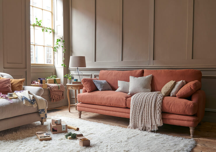light orange couch in neutral living room