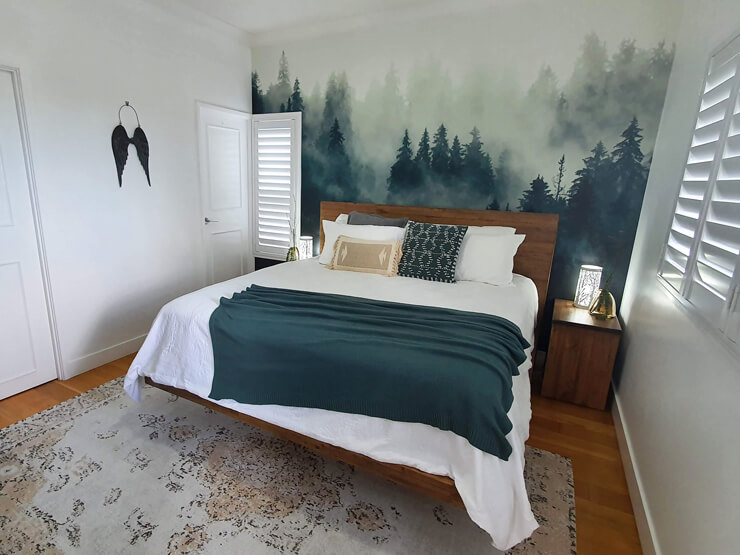 misty forest wall mural in green and white bedroom