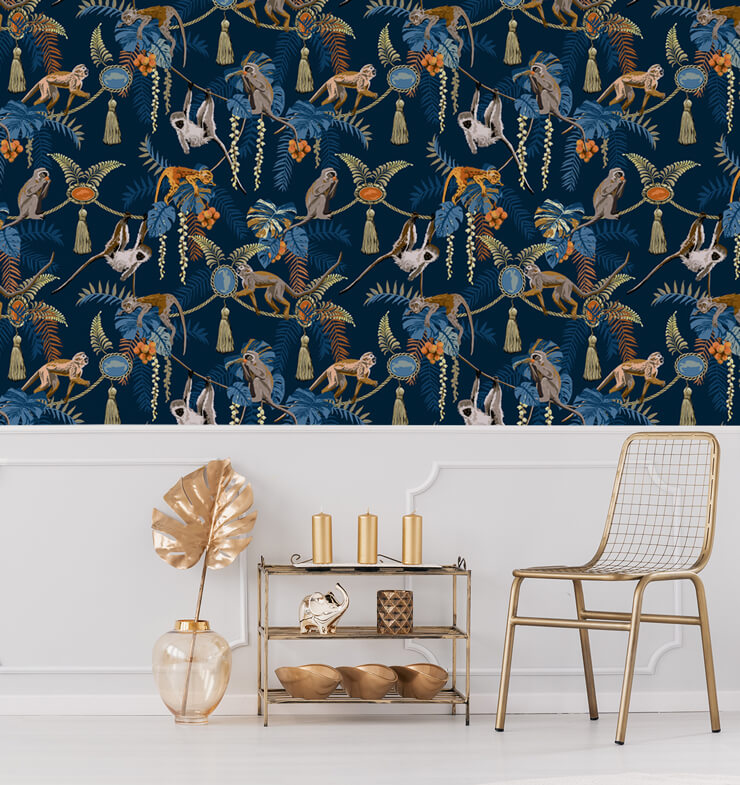 dark blue background and monkey and orange jewels wallpaper in white panelled room with golden chair and accessories