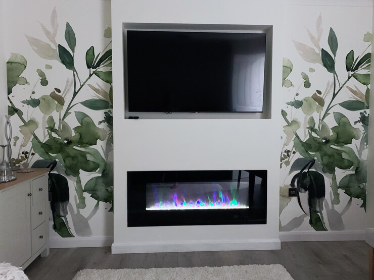 green floral painting wallpaper on a media wall with fireplace
