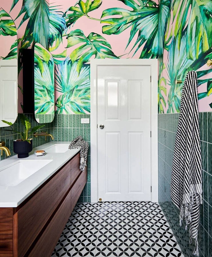 pink and green tropical leaf wallpaper in black and white designer bathroom