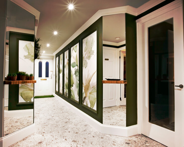 designer hallway with green watercolour wallpaper in panels