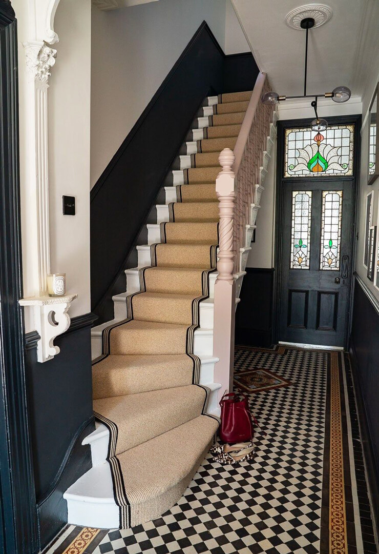 beige carpet runner on stairs in vintage hallway
