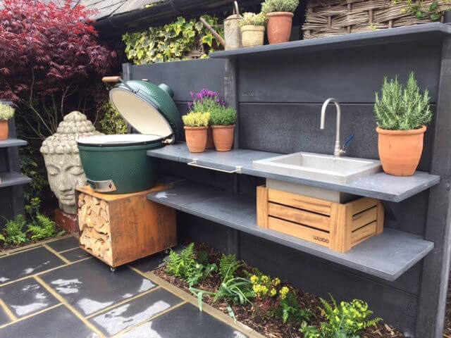 outdoor sink and round green grill