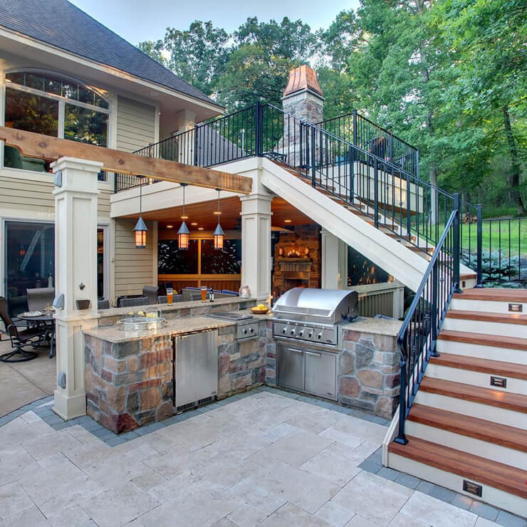 wooden house and stone floored outdoor kitchen with stairs