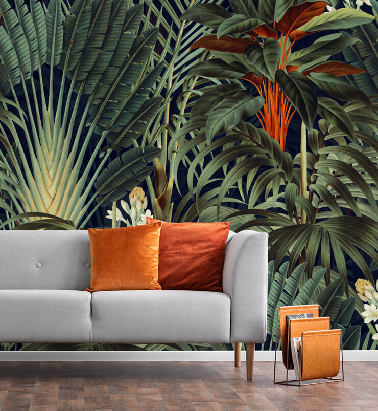 urban jungle trend green palm leaf wallpaper with grey couch and orange cushions 
