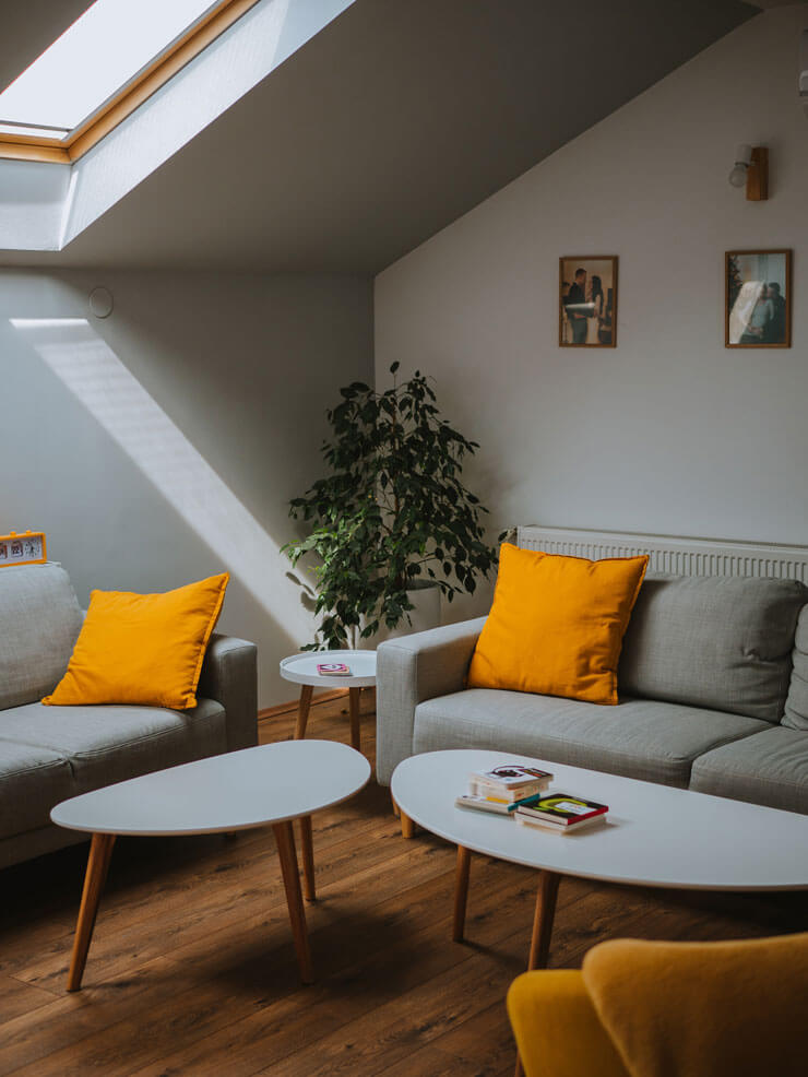 curved coffee tables in an orange and grey living room