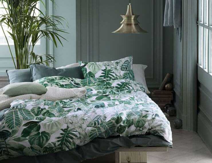 Green bedroom with botanical print bed sheets