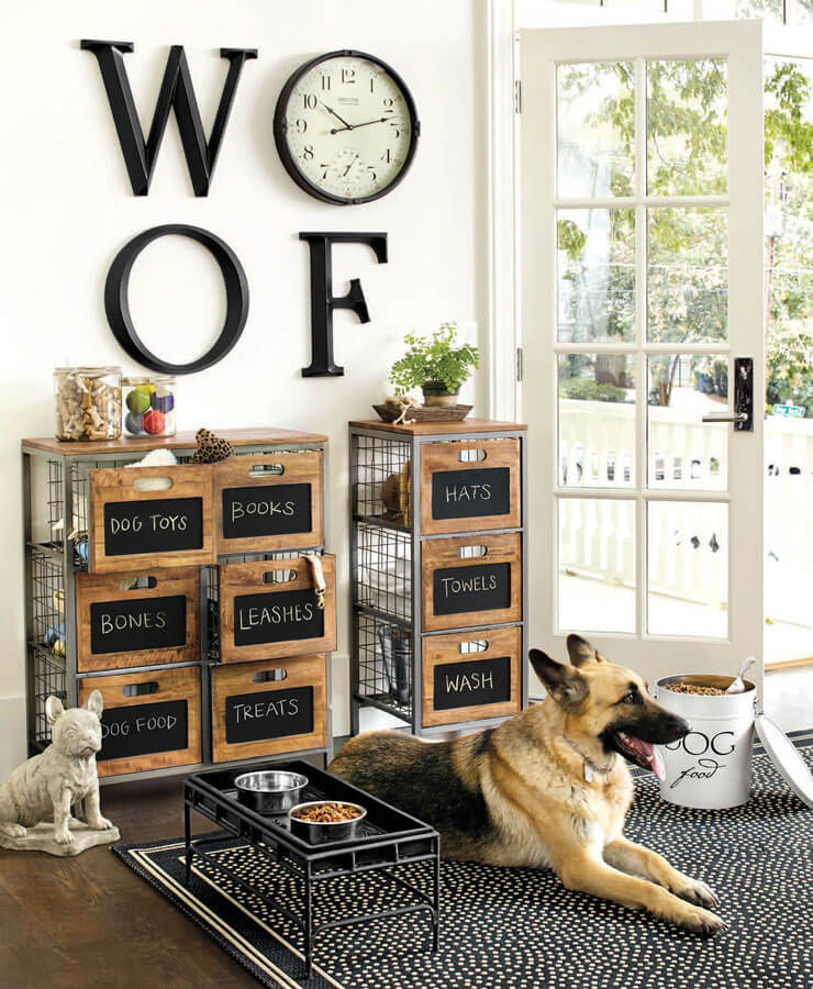 German sheppard sat next to dog storage crates